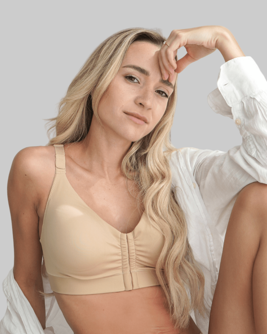 Blonde model wearing after surgery bra with adjustable front closure