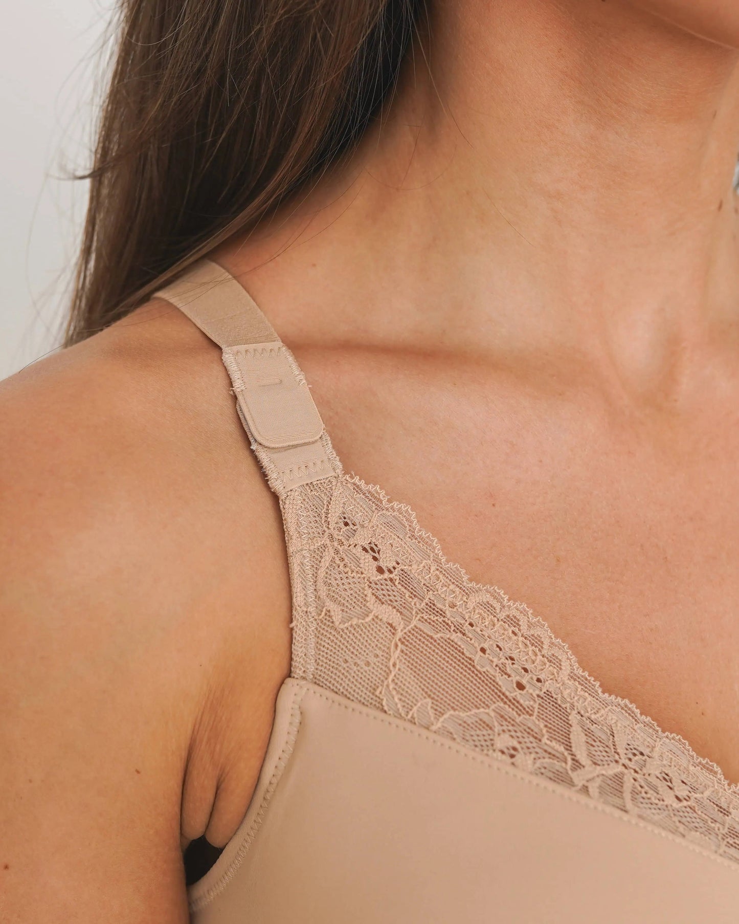 Beige lace-trimmed lingerie on a plain background